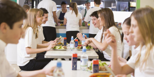 College student preparing gluten-free meal in dorm kitchen.